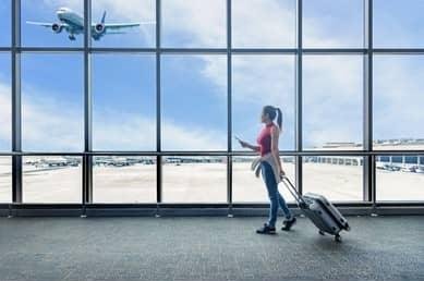 Traveler at the airport watching a plane